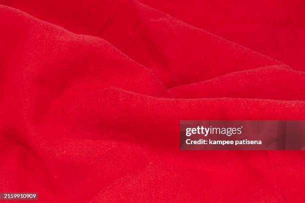 a red cotton fabric with a wave pattern background - bed sheet top view stock pictures, royalty-free photos & images