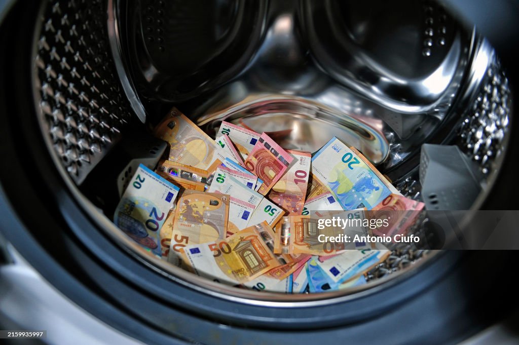 MONEY LAUNDERING - CRIME - FINANCE - EURO. Euro banknotes in a washing machine