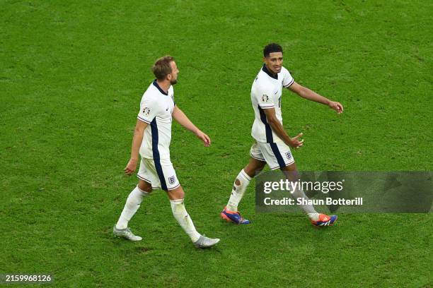 Jude Bellingham of England celebrates with teammate Harry Kane after scoring his team's first goal during the UEFA EURO 2024 round of 16 match...