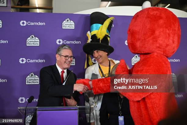 Britain's Labour Party leader Keir Starmer is congratulated by fellow candidates Bobby 'Elmo' Smith and Nick 'The Flying Brick' Delves after winning...