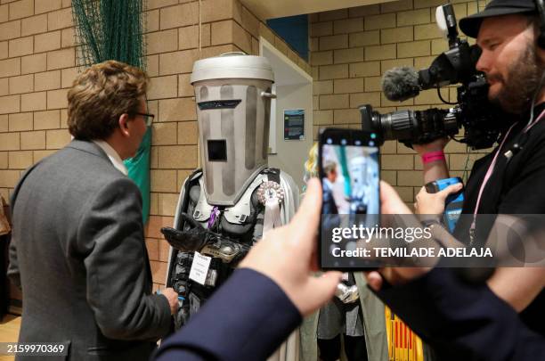 Candidate Count Binface speaks to a journalist as ballots are sorted at the Richmond and Northallerton count centre in Northallerton, north of...