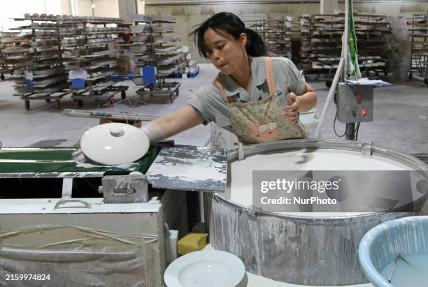 Technician is making daily porcelain for export at the China Jingdezhen Porcelain Factory in Jingdezhen, China, on July 4, 2024.