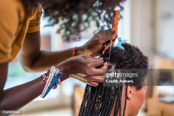 home hair braiding session with mixed race and black women - hair extension stock pictures, royalty-free photos & images
