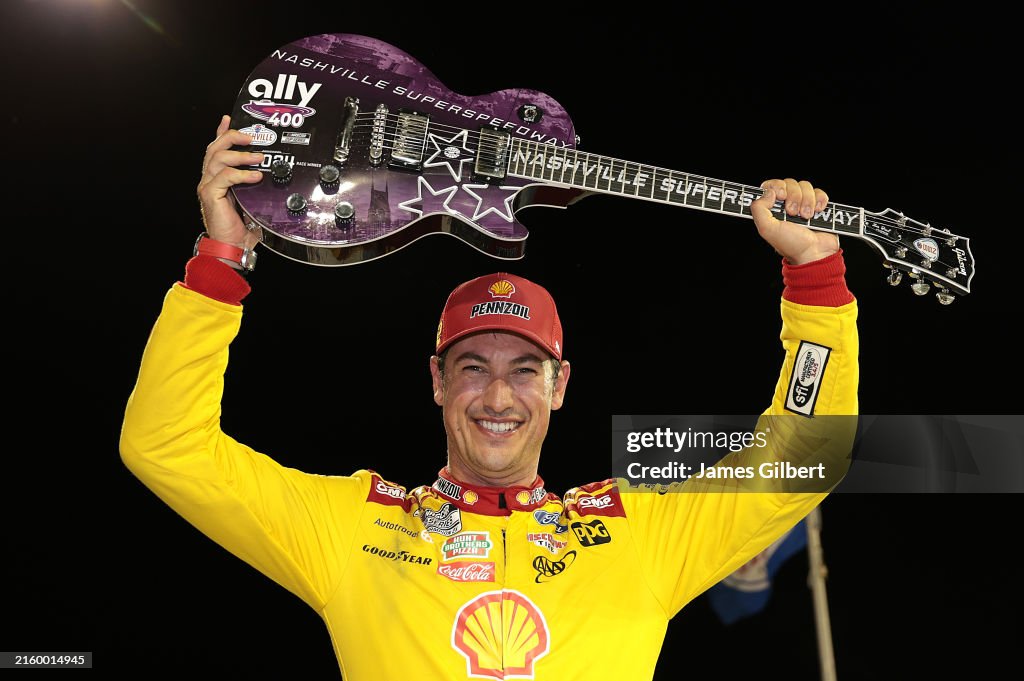 Joey Logano, driver of the Shell Pennzoil Ford, celebrates in victory ...