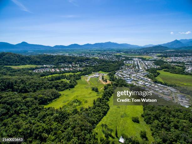 aerial view of bentley park development with lush green foliage and mountains in the distance - queensland stock pictures, royalty-free photos & images