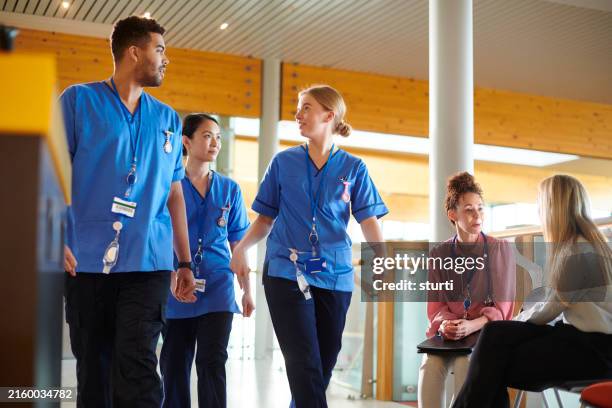 nursing students in hospital corridor - sales executive stock pictures, royalty-free photos & images