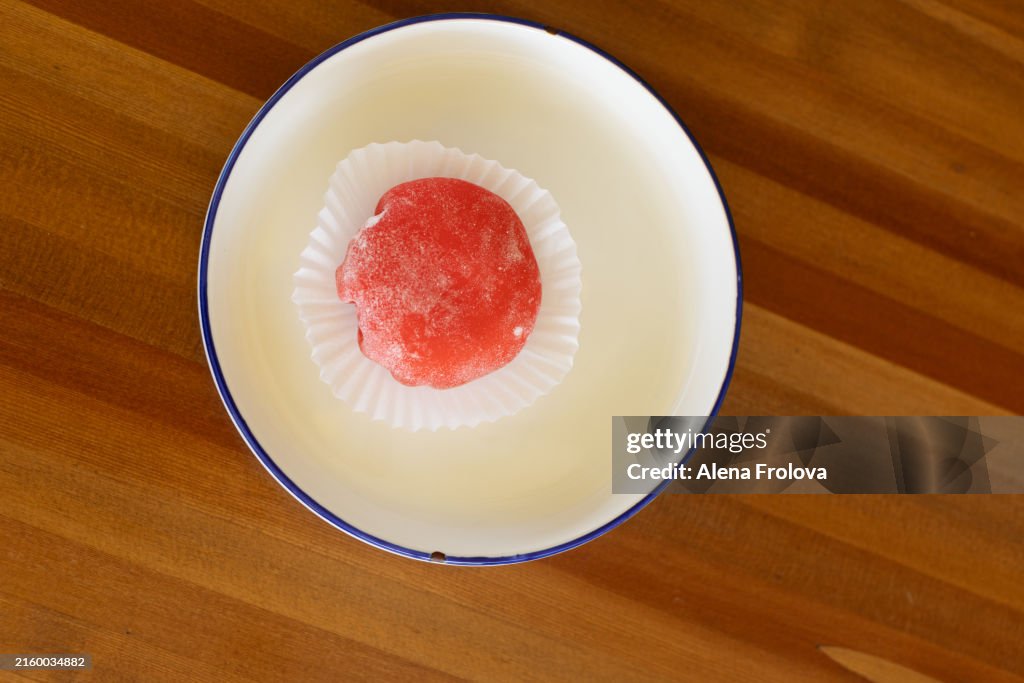 Strawberry mochi on a plate in a cafe