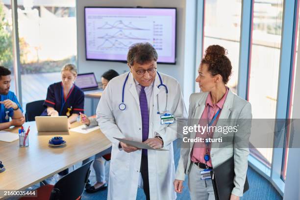 medical meeting with pharmaceutical representatives - medical sales representative stock pictures, royalty-free photos & images