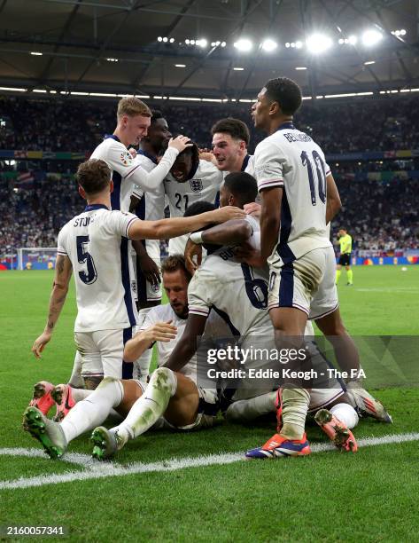 Harry Kane of England celebrates scoring his team's second goal with teammates during the UEFA EURO 2024 round of 16 match between England and...