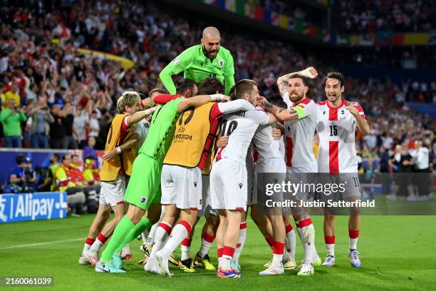 Players of Georgia celebrate after Robin Le Normand of Spain scores an own goal and the first goal for Georgia during the UEFA EURO 2024 round of 16...