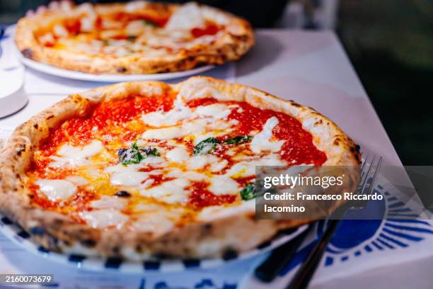 original pizza margherita in a traditional pizzeria, naples, italy. - cheese pizza stock pictures, royalty-free photos & images