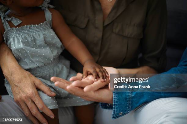 primer plano de manos multigeneracionales - adopción fotografías e imágenes de stock