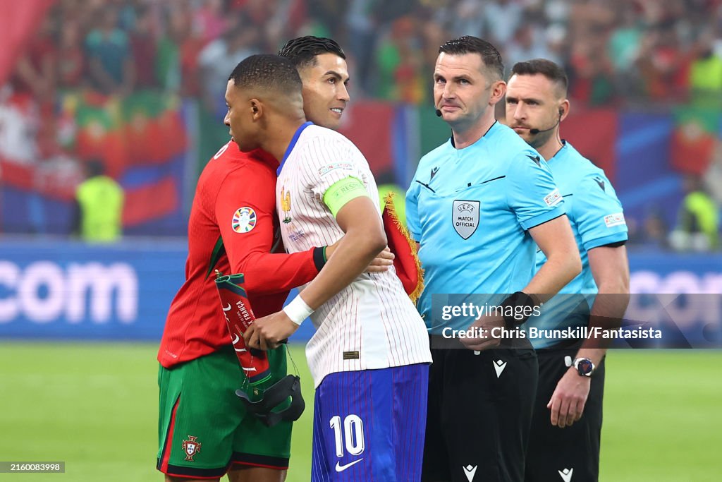 Cristiano Ronaldo Of Portugal Hugs Kylian Mbappe Of France As Referee cristiano-ronaldo-of-portugal-hugs-kylian-mbappe-of-france-as-referee