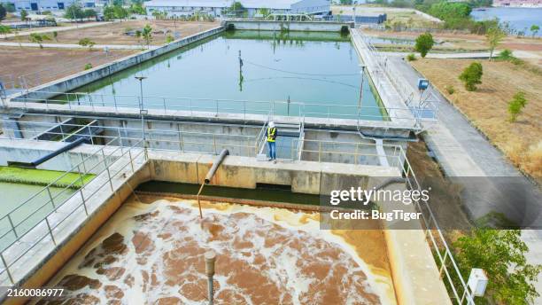 aerial view of environmental engineers work at wastewater treatment plants, water management concept. - estação de tratamento de esgotos imagens e fotografias de stock
