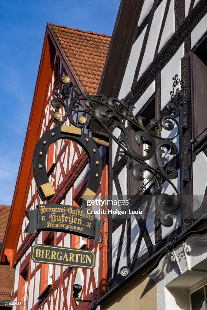 Half-timbered buildings in Altstadt old town with sign for Hufeisen Gasthaus and brewery