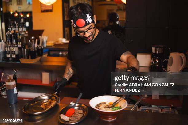 chef finishing plating a ramen bowl - japanese food stock pictures, royalty-free photos & images