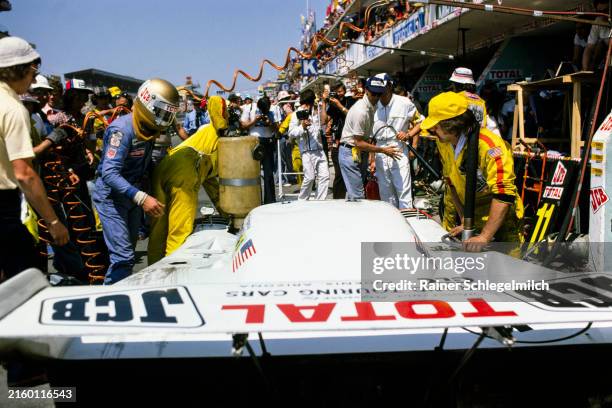 Vern Schuppan climbs into the Grand Touring Cars Inc, Mirage GR8 - Ford Cosworth DFV during a pit stop and driver change during the 24 Hours of Le...