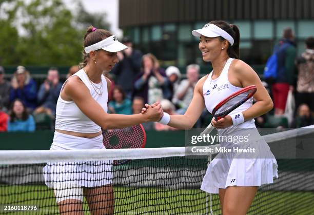 Tamara Korpatsch of Germany meets Yuriko Lily Miyazaki of Great Britain at the net following defeat in the Ladies' Singles first round match on day...