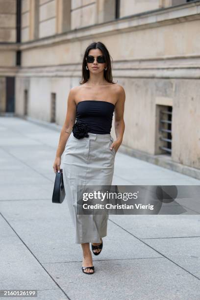Bella Emar wears Levete Room Skirt in grey, Na-kd Bandeau black off shoulder Top, Mango Heels, Coperni Bag, Miu Miu Sunglasses during the Berlin...