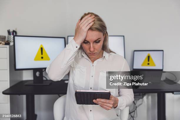 person frustrated with computer warning symbols on monitors - ransomware stock pictures, royalty-free photos & images