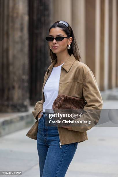 Bella Emar wears Levi’s blue denim jeans, white Cos t-shirt, brown Massimo Dutti Jacket during the Berlin Fashion Week Spring/Summer 2025 on July 01,...