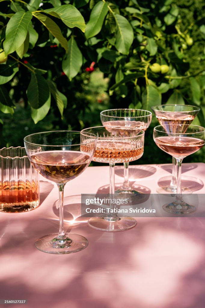 Several Cocktail or mocktail glasses with rose wine drink