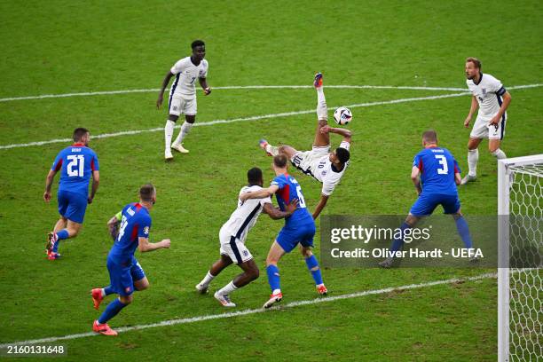Jude Bellingham of England, scores his team's first goal with a overhead kick during the UEFA EURO 2024 round of 16 match between England and...