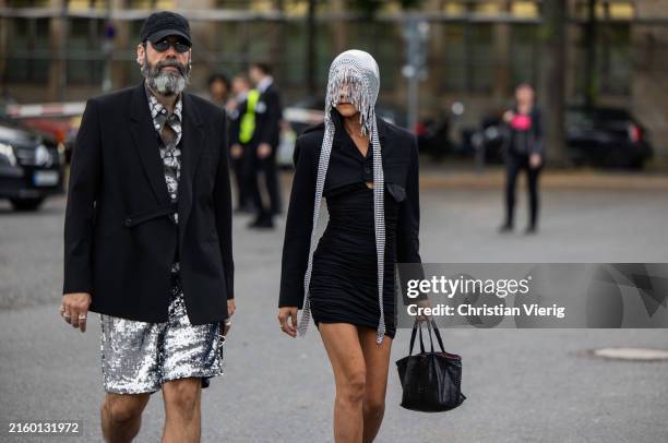 Guest wears silver sequined shorts and a guest wears head piece outside Lueder during the Berlin Fashion Week SS25 on July 01, 2024 in Berlin,...