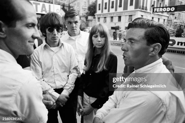 Jim Clark in dialogue with fans including Beatle George Harrison during the Monaco GP at Monte Carlo on May 22, 1966 in Monte Carlo, Monaco.