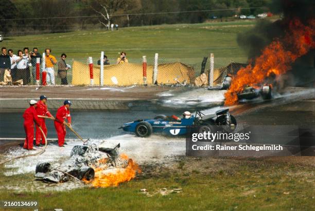 Jackie Stewart, March 701 Ford drives between the flaming wrecks of Jackie Oliver's BRM P153 and Jacky Ickx's Ferrari 312B during the Spanish GP at...