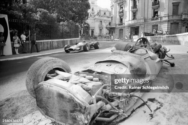 Graham Hill, Lotus 49B Ford passes Pedro Rodriguez' destroyed BRM P133 during the Monaco GP at Monte Carlo on May 26, 1968 in Monte Carlo, Monaco.