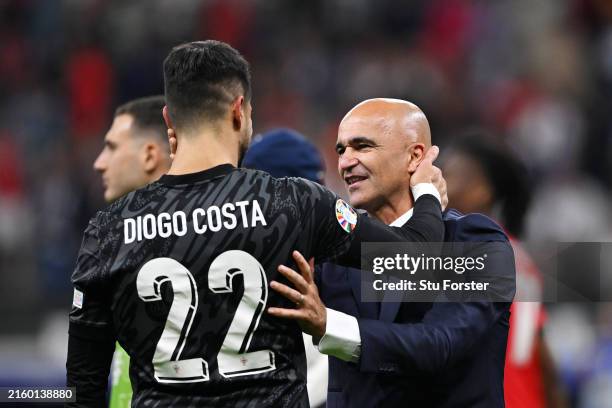 Roberto Martinez, Head Coach of Portugal, celebrates with Diogo Costa of Portugal following the team's victory in the penalty shoot out during the...