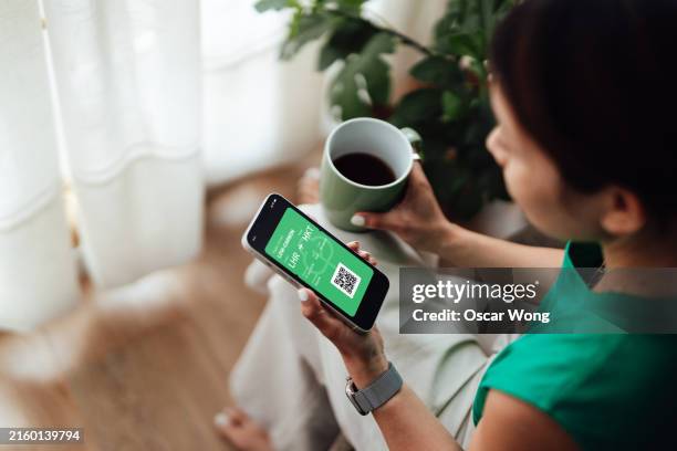 young woman with smart phone showing electronic flight ticket - self service check in stock pictures, royalty-free photos & images