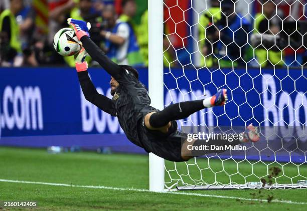 Diogo Costa of Portugal saves the third penalty from Benjamin Verbic of Slovenia in the penalty shoot out during the UEFA EURO 2024 round of 16 match...