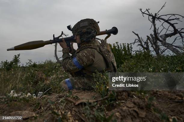 The infantryman looks at the explosion next to him. Ukrainian infantry on the zero line of the front in prepared trenches 100 meters from the Russian...