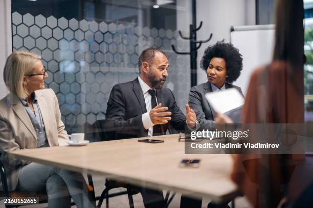 boardroom meeting with diverse executives - shareholder stock pictures, royalty-free photos & images