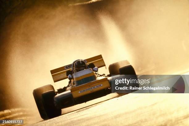 Graham Hill, Brabham BT34 Ford, with backlit spray from the wet track during the Spanish GP at Montjuïc on April 18, 1971 in Montjuïc, Spain.