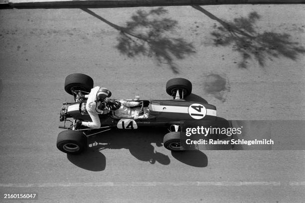 Graham Hill, Lotus 33 BRM, gives Jo Siffert a lift back to the pits during practice during the Monaco GP at Monte Carlo on May 06, 1967 in Monte...