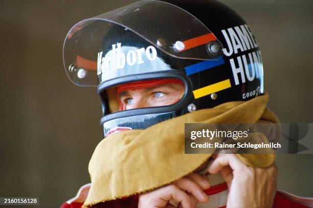 James Hunt makes an adjustment to his helmet during the Austrian GP at Red Bull Ring on August 14, 1977 in Red Bull Ring, Austria.