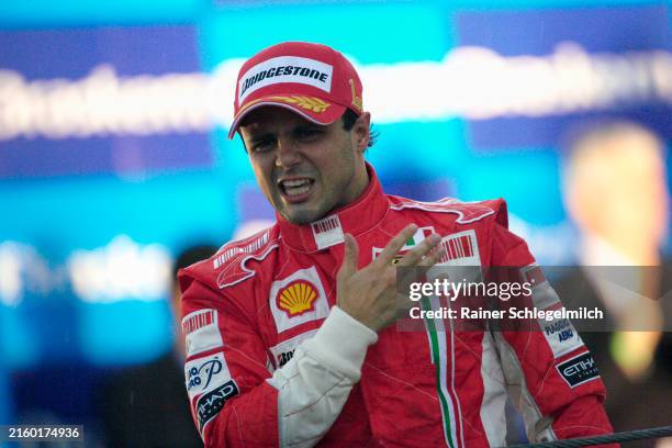 An emotional Felipe Massa proudly slaps the Prancing Horse insignia on his chest as he celebrates victory and a well fought season in front of his...