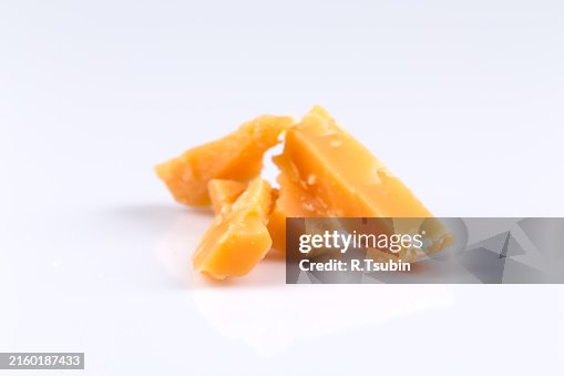 Piece of old hardcheese on a white background isolated Piece of old hardcheese on a white background isolated