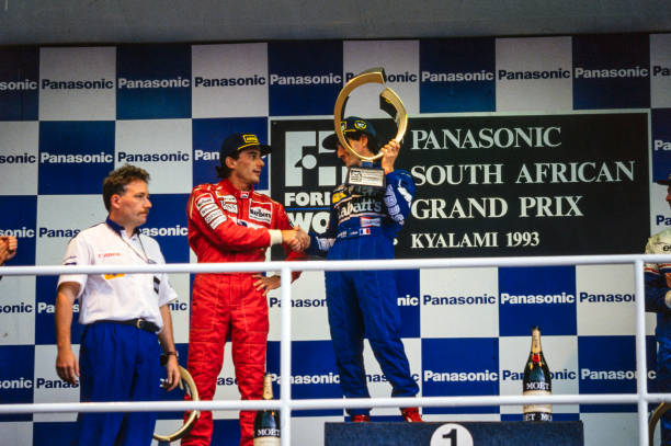 Ayrton Senna, 2nd position, congratulates Alain Prost, 1st position, on the podium during the South African GP at Kyalami on March 14, 1993 in...