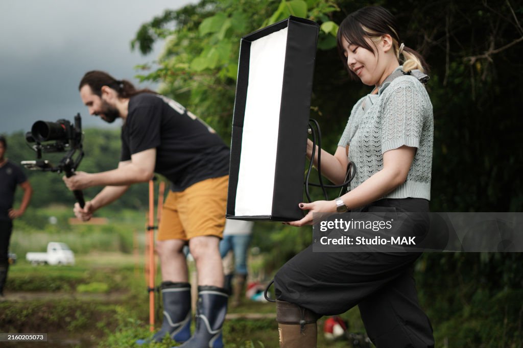Two videographer taking professional videos in a traditional Japanese rice field