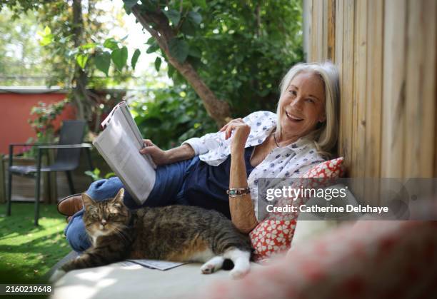 portrait of an elderly woman posing on her terrace - zen-like stock pictures, royalty-free photos & images