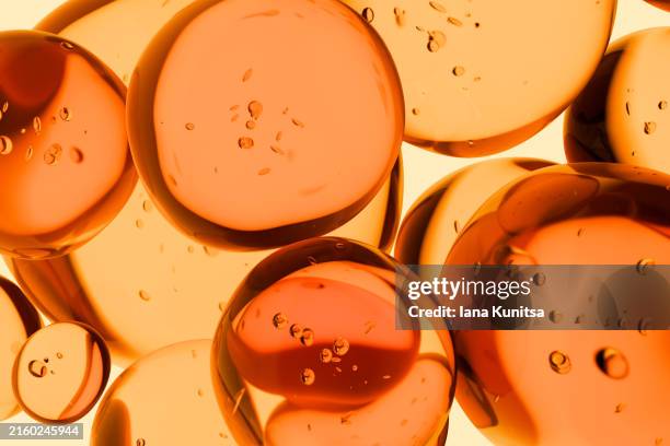 transparent orange oil drops, bubbles, molecules. close-up. 3d pattern. healthcare and medicine. cosmetic products for skin care. citrus. vitamin c. - liquid fish oil stock pictures, royalty-free photos & images