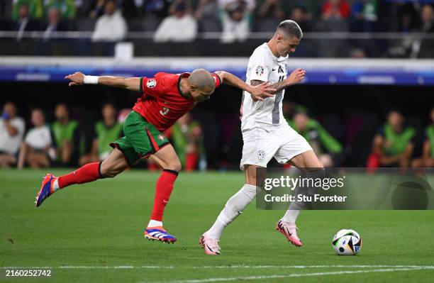 Pepe of Portugal is outpaced by Slovenia forward Benjamin Sesko during the UEFA EURO 2024 round of 16 match between Portugal and Slovenia at...