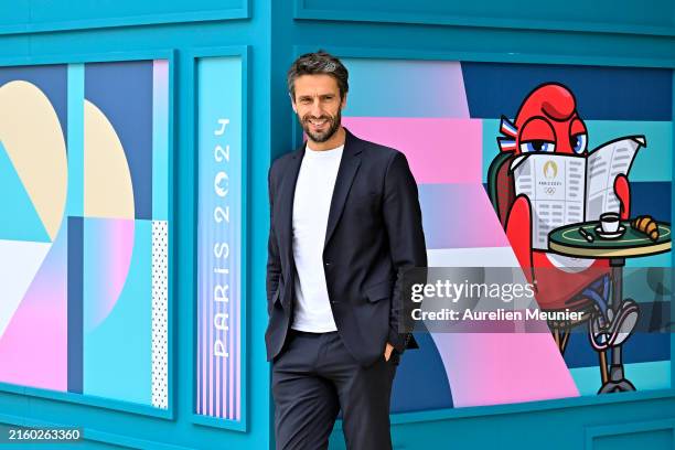 Paris 2024 President Tony Estanguet poses in front of a newspaper koisk during the media visit of Paris 2024 Olympic and Paralympic village on July...