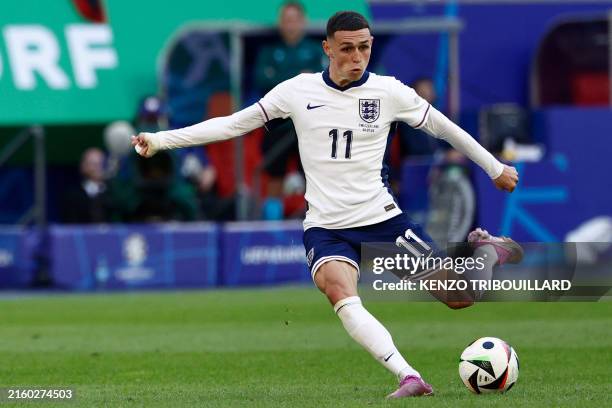 England's midfielder Phil Foden kicks the ball during the UEFA Euro 2024 quarter-final football match between England and Switzerland at the...