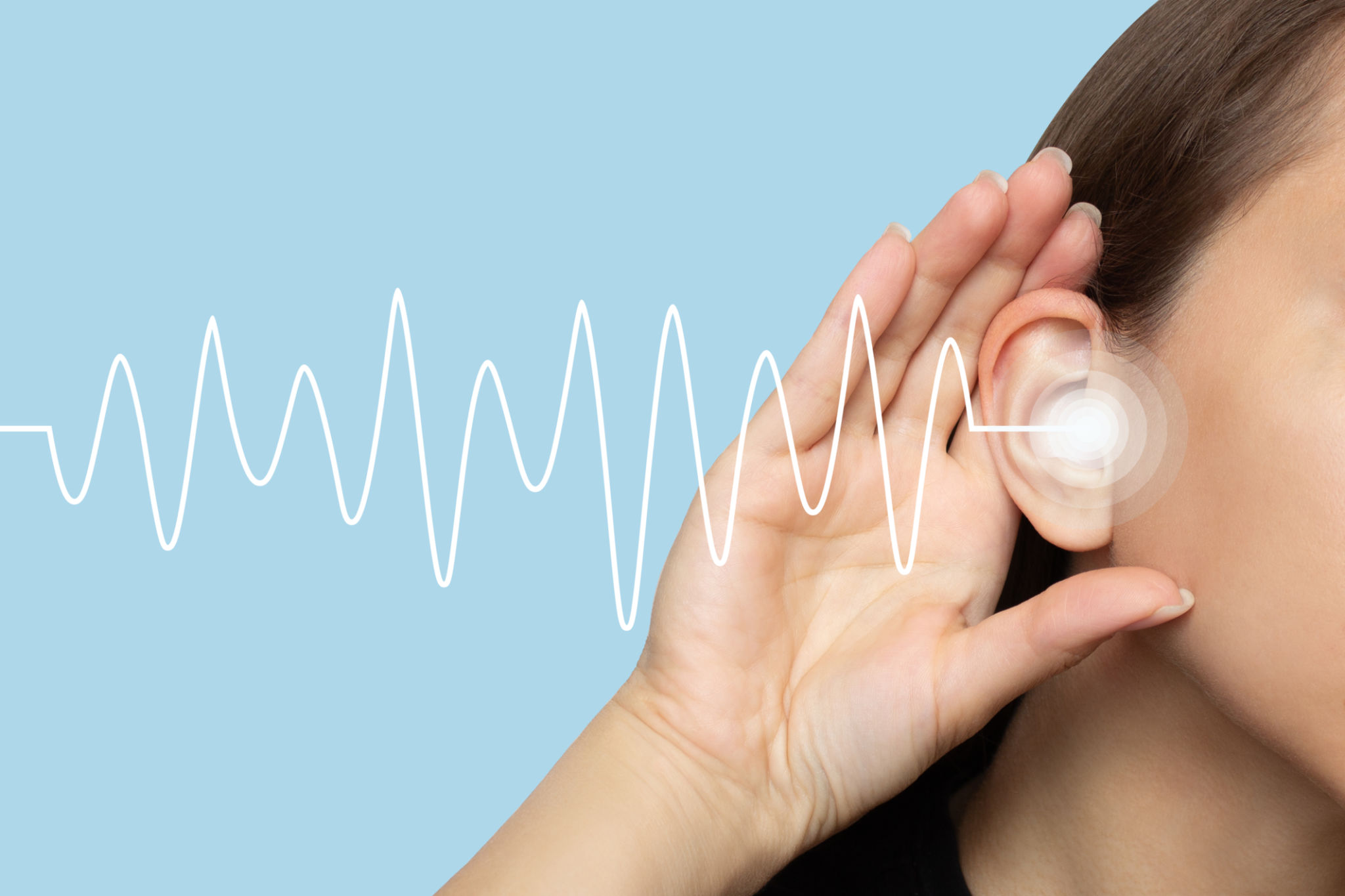 A woman puts her hand to her ear and listens A woman puts her hand to her ear and listens