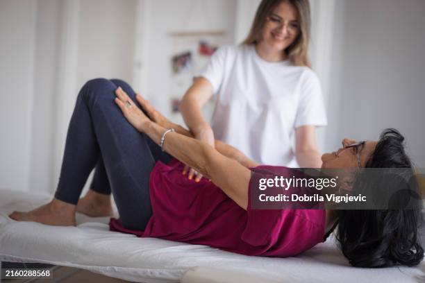 orthopedic nurse helping patient exercise - hernia stock pictures, royalty-free photos & images